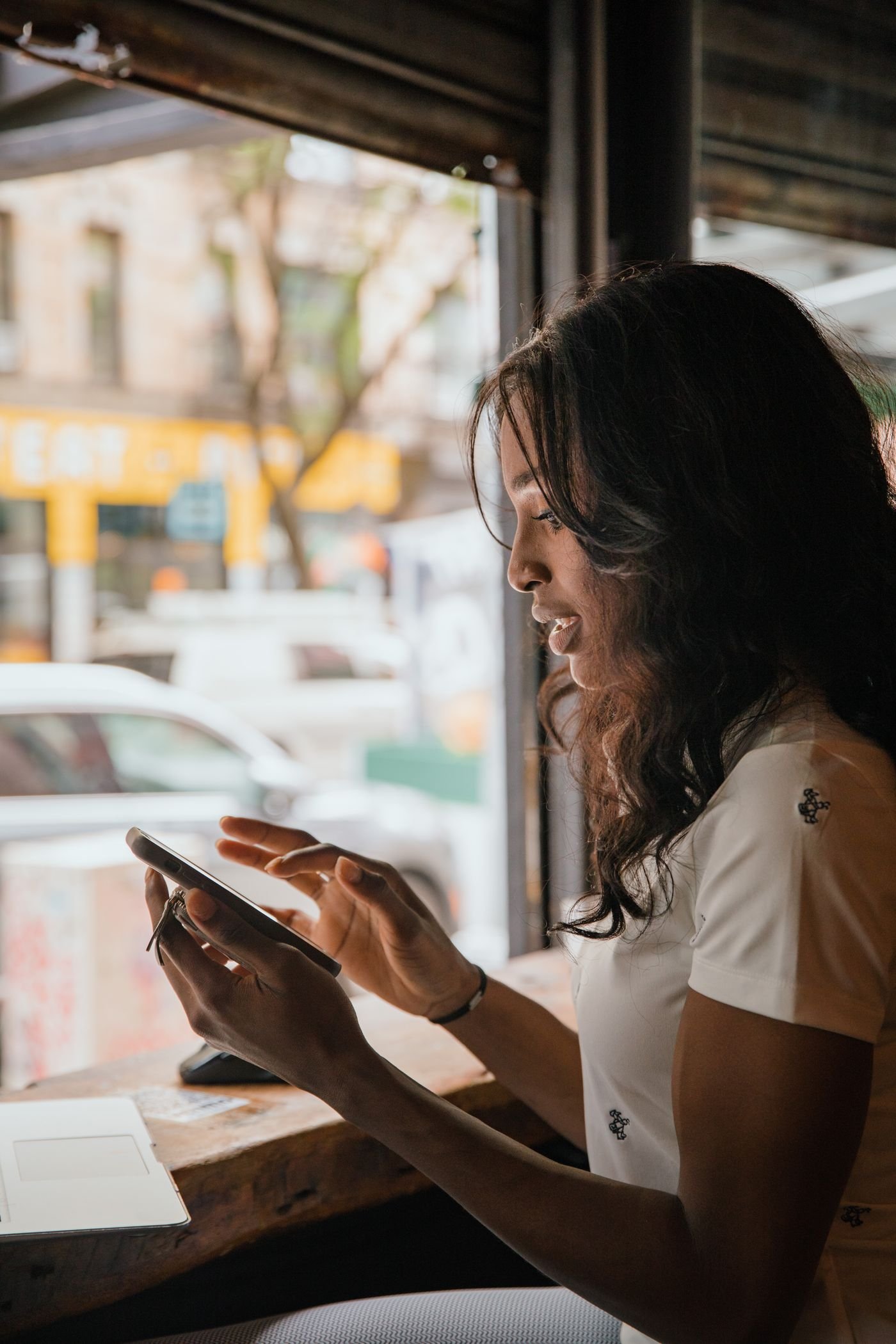 Person checking a smartphone while seated in a café